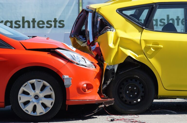 Car accident scene with damaged vehicles, emphasizing veterinary care for pets at AMCP.
